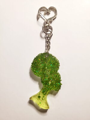heart-shaped keychain hook with a resin mold shaped as a woman with an up-do afro hairstyle with green glitter decorations