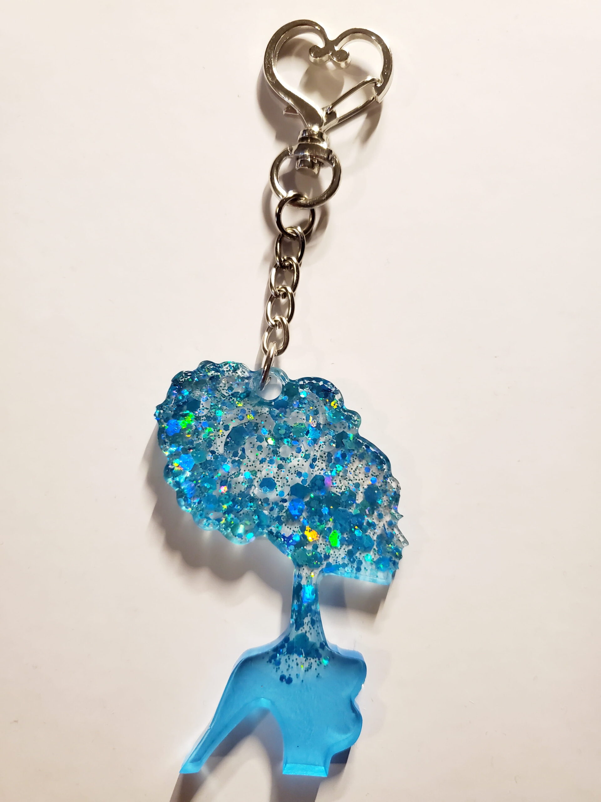 heart-shaped keychain hook with a resin mold shaped as a woman with updo hair style with blue glitter decorations