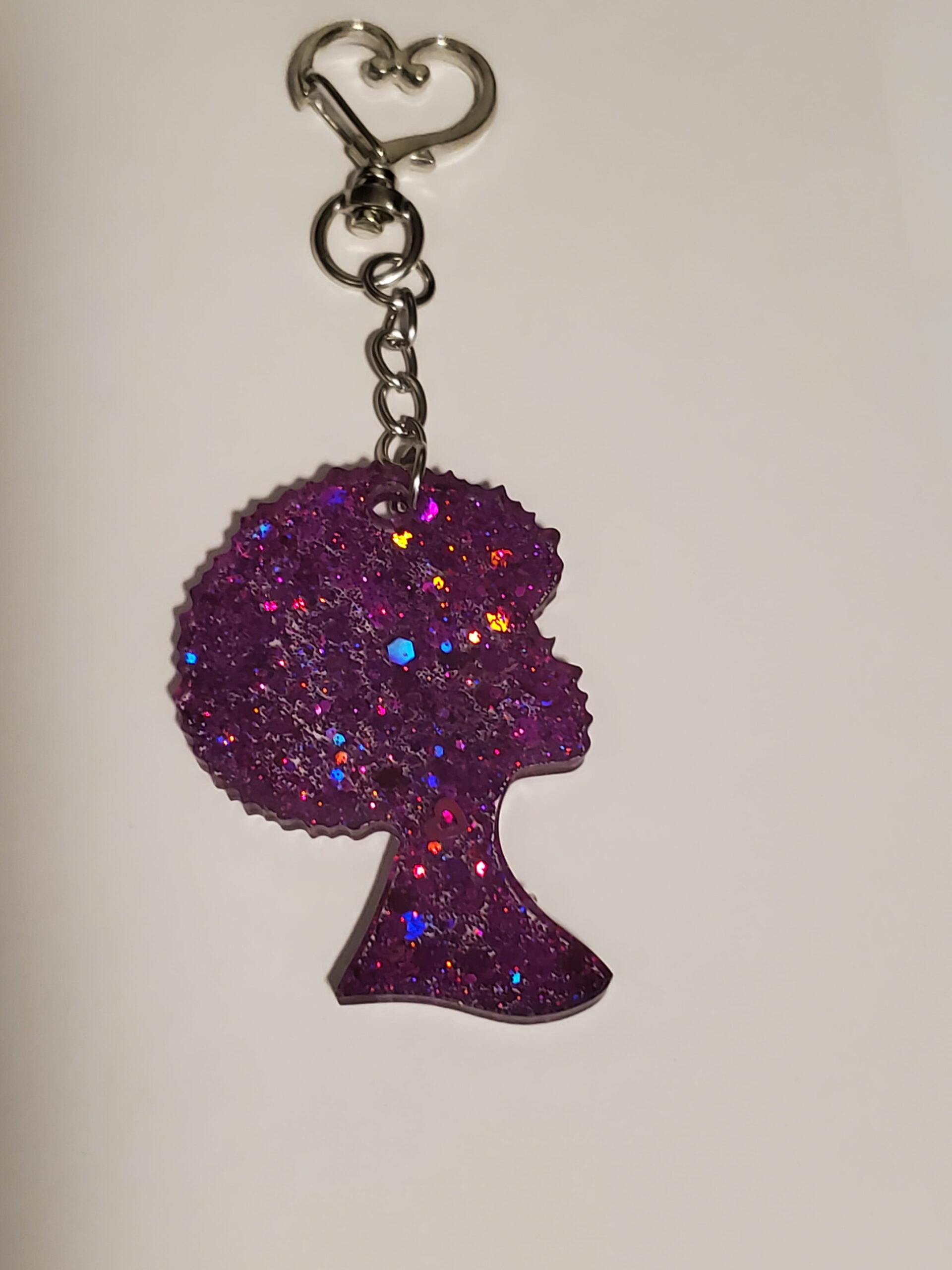 heart-shaped keychain hook with a resin mold shaped as a woman with afro hairstyle with purple glitter decorations